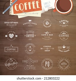 Set of vintage style elements for labels and badges for coffee, with wood texture, cup of coffee and a notepad in the background    