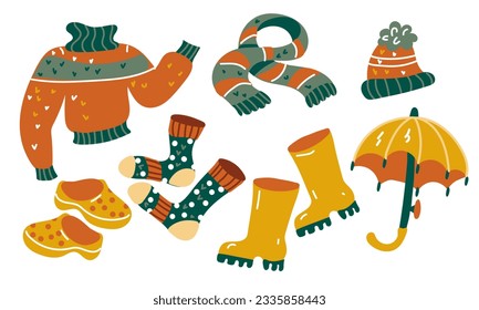 A set of warm cozy autumn clothes and shoes. Cartoon flat vector illustration. Colorful elements for your design. Warm shades. Autumn clothes. Sweater, socks, scarf, hat, umbrella, boots.