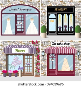 Set of wedding shops. Bridal boutique, jewelry, flowers  and the cake shop. Building facade of stone. Vector illustration eps 10.