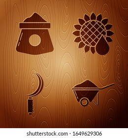 Set Wheelbarrow with dirt, Bag of flour, Sickle and Sunflower on wooden background. Vector