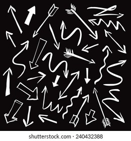 A set of white arrows on black background drawn with a brush. Useful graphic elements for presentations. Isolated Vector Graphics.