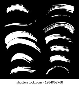 Set of white brush strokes. Dirty artistic design elements.