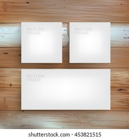 Set of white canvas frame on wooden wall. Vector picture frame background for interior design and decoration.