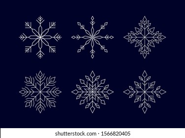 Set of white geometry snowflakes on dark blue background. Isolated winter icons. Suitable for banner, poster, card.