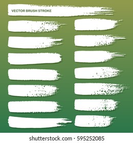 Set of white grunge brush strokes isolated on green background. Vector illustration.
