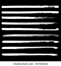Set of white hand drawn lines on black background vector illustration. Hand drawn brush stroke