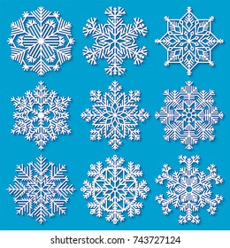 Set of white highly detailed geometrical snowflakes on blue background. Vector illustration