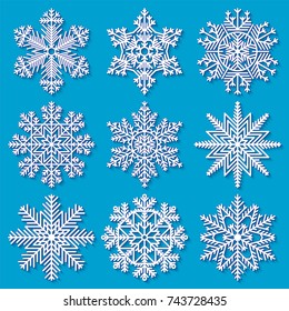 Set of white highly detailed geometrical snowflakes on blue background. Vector illustration