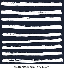 Set of white horizontal hand drawn brushes on dark blue background. Abstract seamless pattern. Grunge lines, or stripes. Vector illustration.