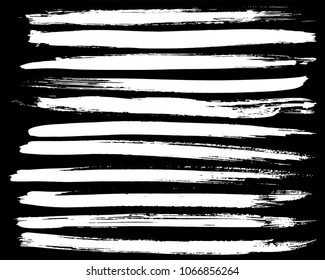 Set of white ink vector stains. Grunge brush collection isolated on black
