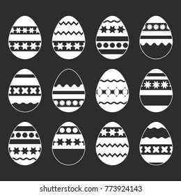 Set of white isolated silhouettes of Easter eggs on a black background. With an abstract pattern. Simple flat vector illustration. Suitable for decoration of postcards, advertising, magazines