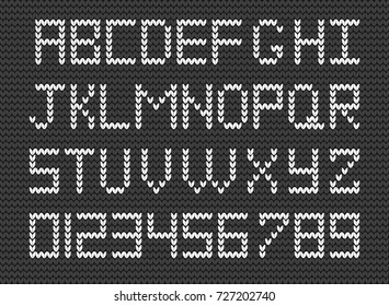 Set of  white knitted alphabet and numerals on grey knitted background. Vector illustration of  knitted symbols and knitted numbers. Knit script. Fabric christmas or new year script.
