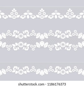 Set of white lace borders isolated on a dray background