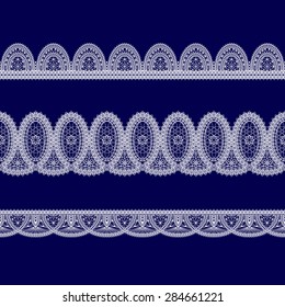 set of white lace ribbons on a blue background