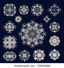 Set of white lace rosettes - snowflakes  on dark background