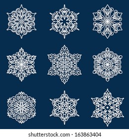 Set of white lacy ornamental vector snowflakes