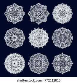 Set of white ornamental vector rosettes on dark background