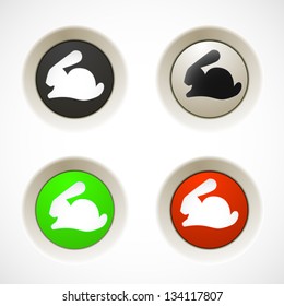 Set of white, red, green, plastic buttons with rabbit silhouette