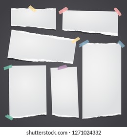 Set of white ripped notebook paper, torn note paper strips stuck with colorful sticky tape on black background. Vector illustration