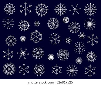 Set of white snowflakes isolated on blue. Vector. 