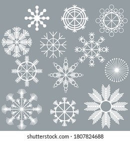 Conjunto de copos de nieve blancos sobre un fondo gris, sutiles patrones de hielo de líneas rectas y elementos redondos, atributos navideños de invierno para el diseño y la creatividad