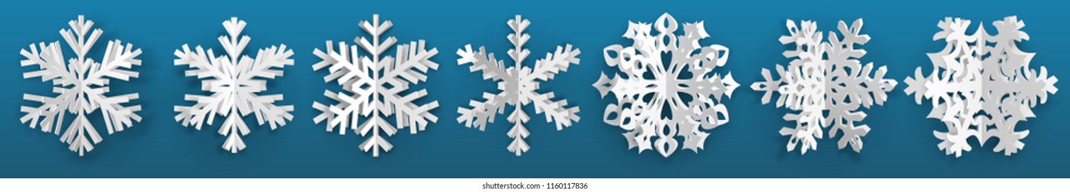 Set of white three-dimensional paper snowflakes on light blue background