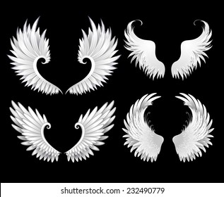 Set of white wings on black background.