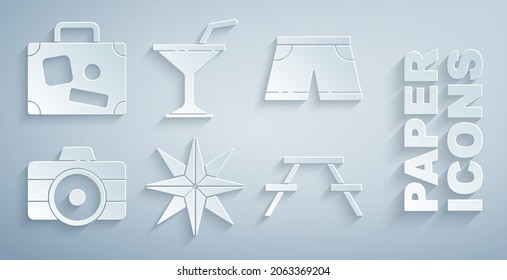 Set Wind rose, Swimming trunks, Photo camera, Picnic table with benches, Martini glass and Suitcase icon. Vector