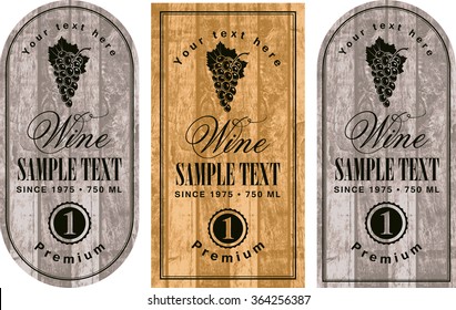 set of wine labels with grapes on the background of wooden boards