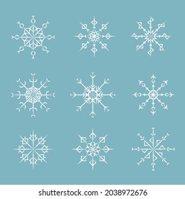 Juego de copos de nieve de invierno aislados en un fondo azul. Decoración de celebraciones. Ilustración del vector