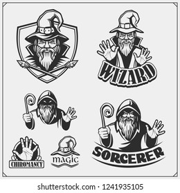 Set of wizard or magician emblems, labels and design elements. Illustrations of sorcerer with black pointed hat and cloak.