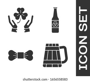 Set Wooden beer mug, Human hands holding four leaf clover, Bow tie and Beer bottle with four leaf clover icon. Vector