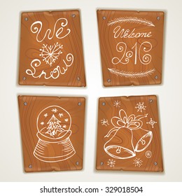 Set of wooden boards with hand drawn Christmas and New Year themed elements. Vector illustration for your graphic design.
