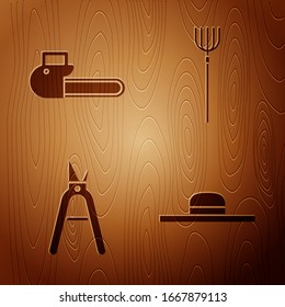 Set Worker hat, Chainsaw, Gardening handmade scissors and Garden pitchfork on wooden background. Vector