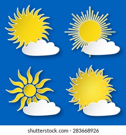 Set of yellow paper shining suns and white clouds on the blue sky.