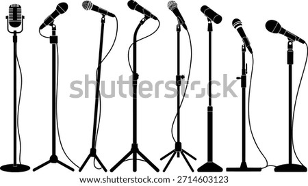 Seven Black Microphone Stands with Different Microphones on White Background