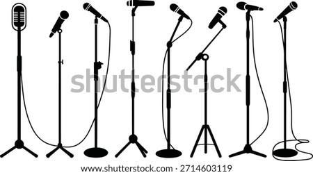 Seven different types of microphones on stands in black and white