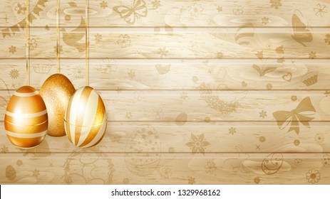 Several golden Easter eggs hanging on background of wooden planks with holyday symbols like flowers, cakes, hare, hen, chicken, bow and other