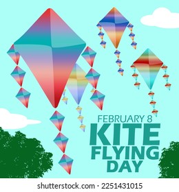 Several kites with colorful decorations flying high above the cloudy blue sky and trees to commemorate Kite Flying Day on February 8