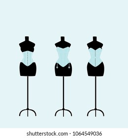 several light mannequins with corsets on a light blue background.