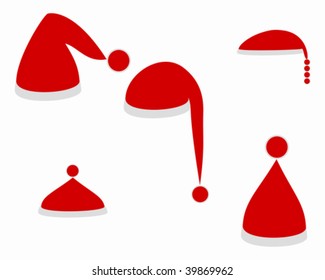 Several red caps of Santa Claus on white