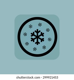 Several snowflakes in circle, in square, on pale blue background