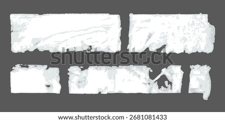 Several white ripped paper posters with glue residues on the wall bg