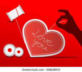 Sewing Paper Heart with Human Hand on Red Background