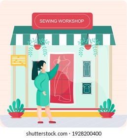 Sewing workshop. Atelier building facade with awning and big showcase window, modern fashion professional tailor shop. Woman seamstress makes pattern of female stylish dress lay out pattern on fabric