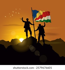 Seychelles flag, silhouette of two climbers holding flags at sunset