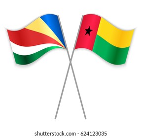 Seychellois and Bissau-Guinean crossed flags. Seychelles combined with Guinea-Bissau isolated on white. Language learning, international business or travel concept.