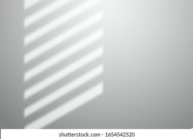 Shadow from the blinds on a white wall. Mocup for design