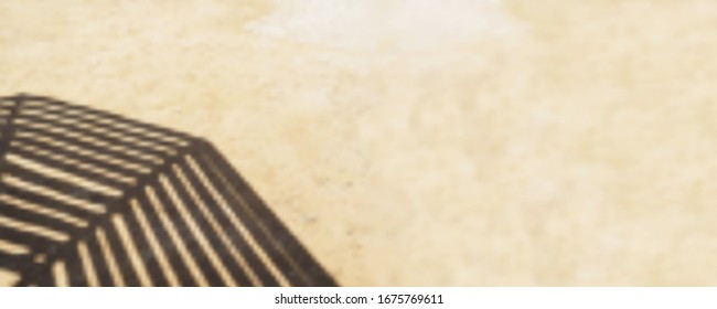 Shadow from wooden sun umbrella on sand. Long blurred vector background. Beach sand and defocused shadow. EPS10. Place for your text.