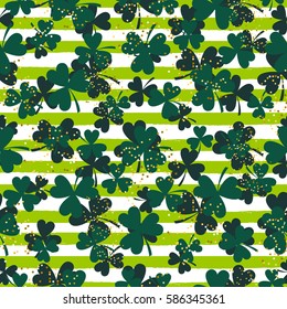Shamrock green striped trefoil leaf seamless vector pattern. St. Patricks day green clover glitter background.